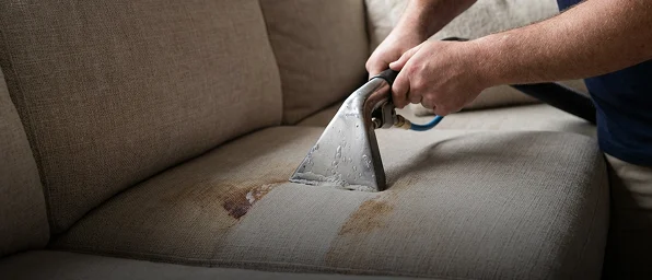 Technician cleaning a fabric armchair during upholstery cleaning in Point Cook